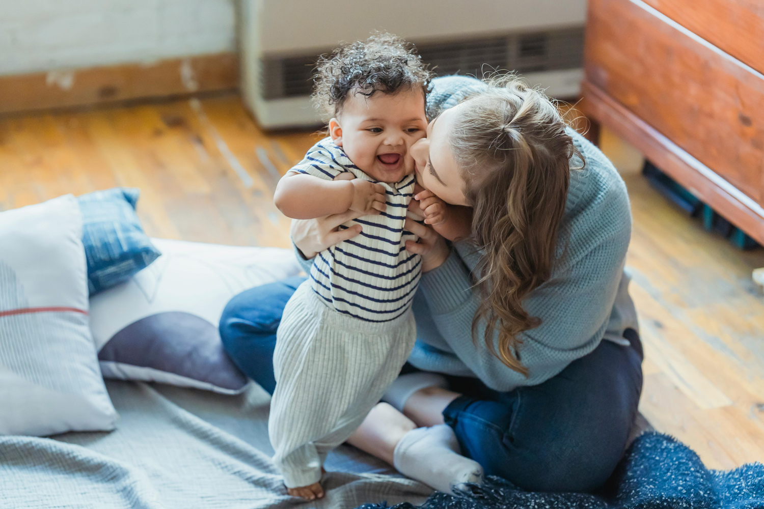 Mum holding smiling baby