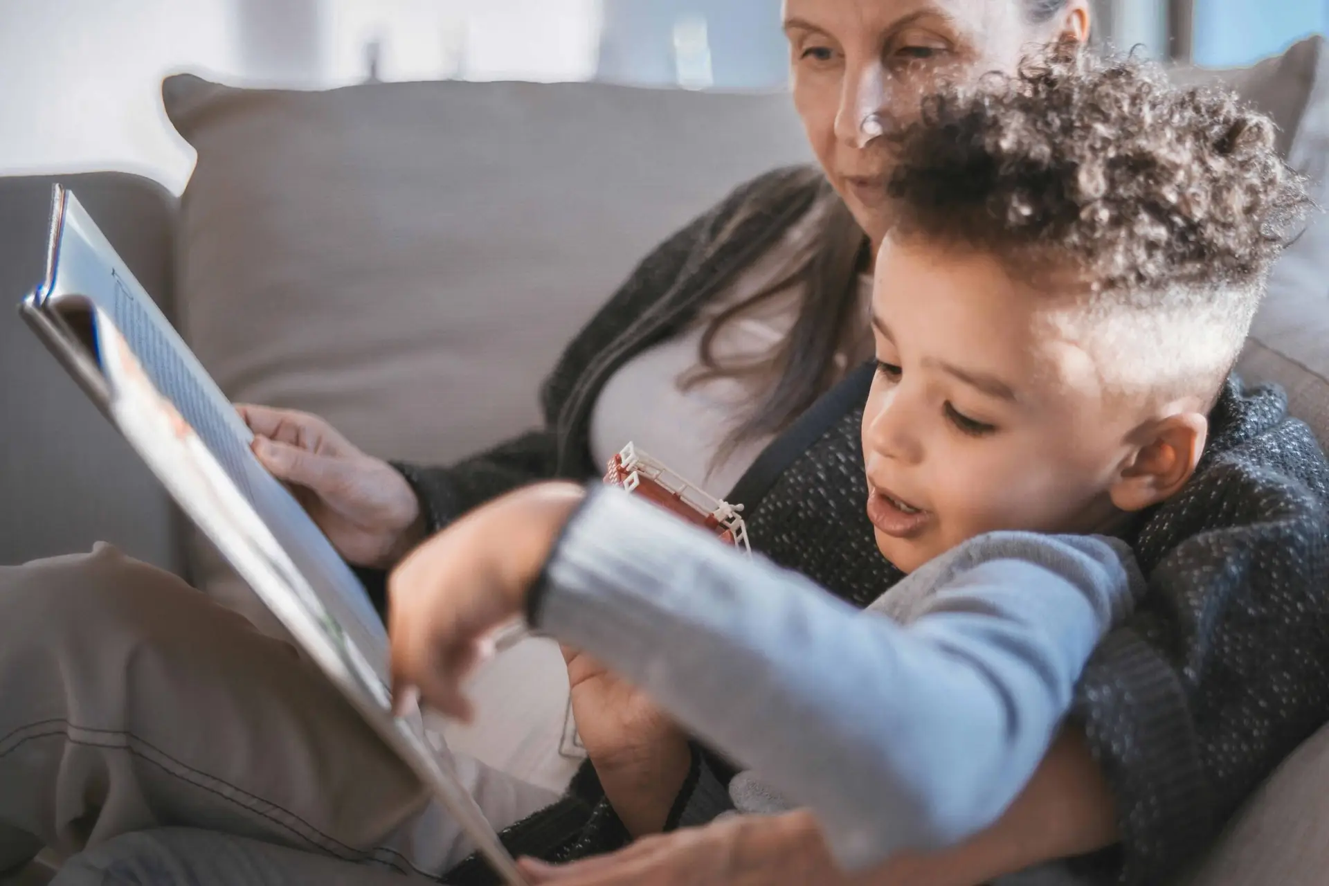grandmother and grandson reading together