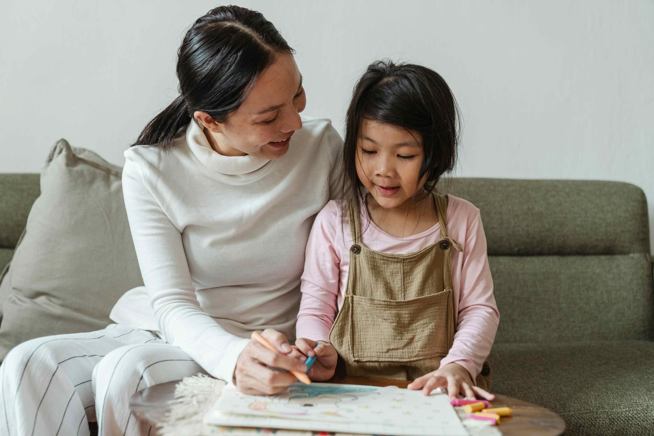 mum and young daughter colouring in together