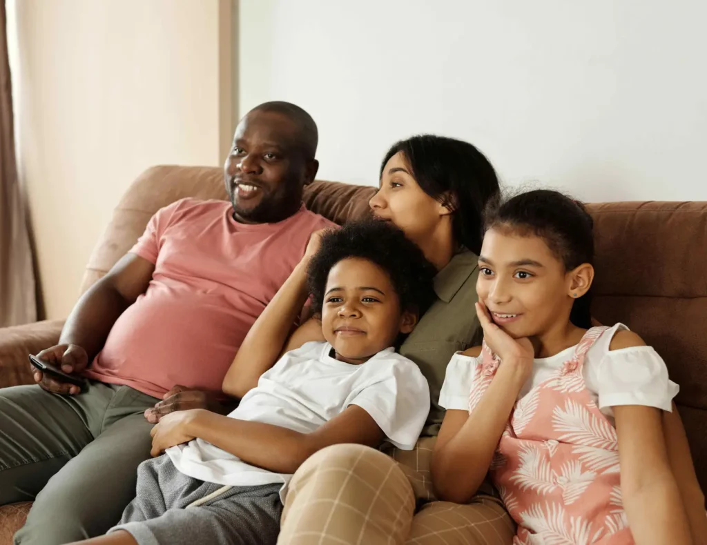 family of four sitting on sofa