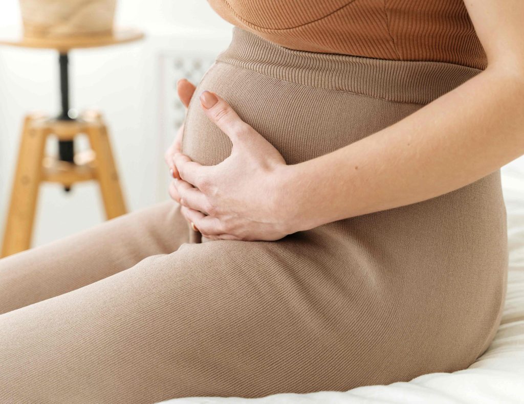 pregnant mother with hands on baby bump