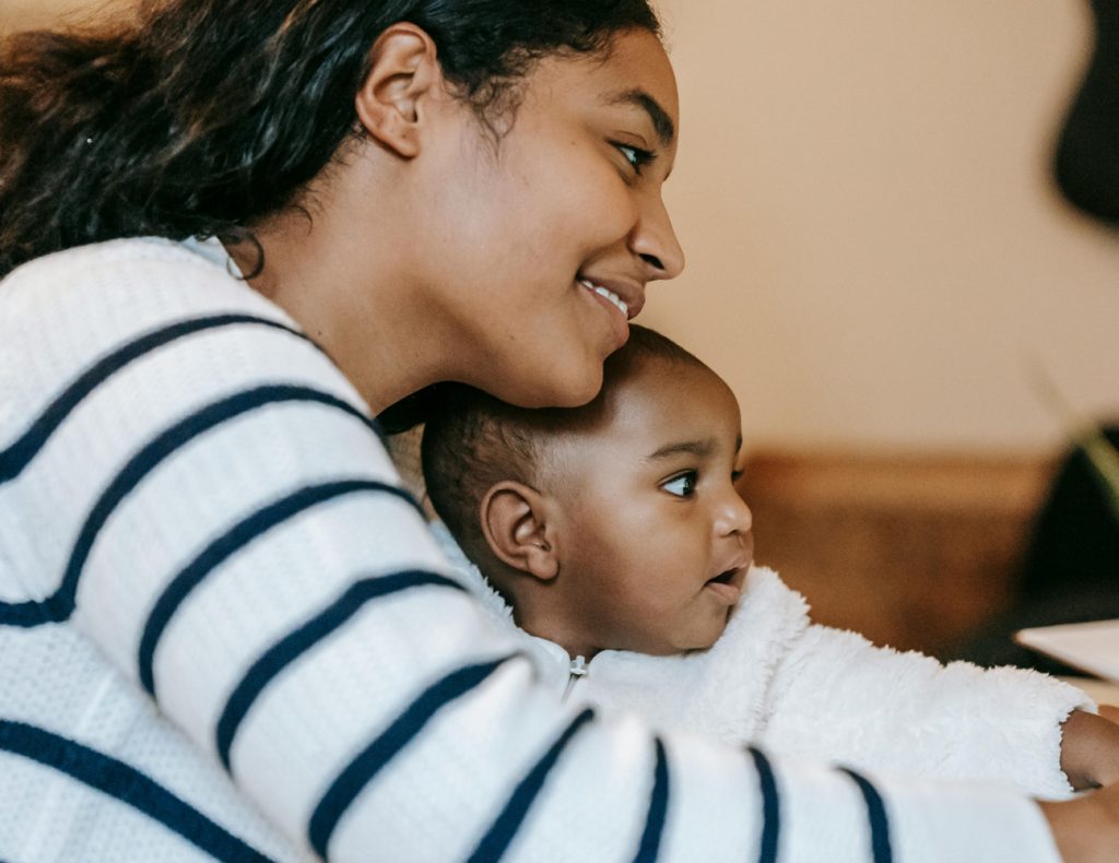 smiling mum engaged with baby